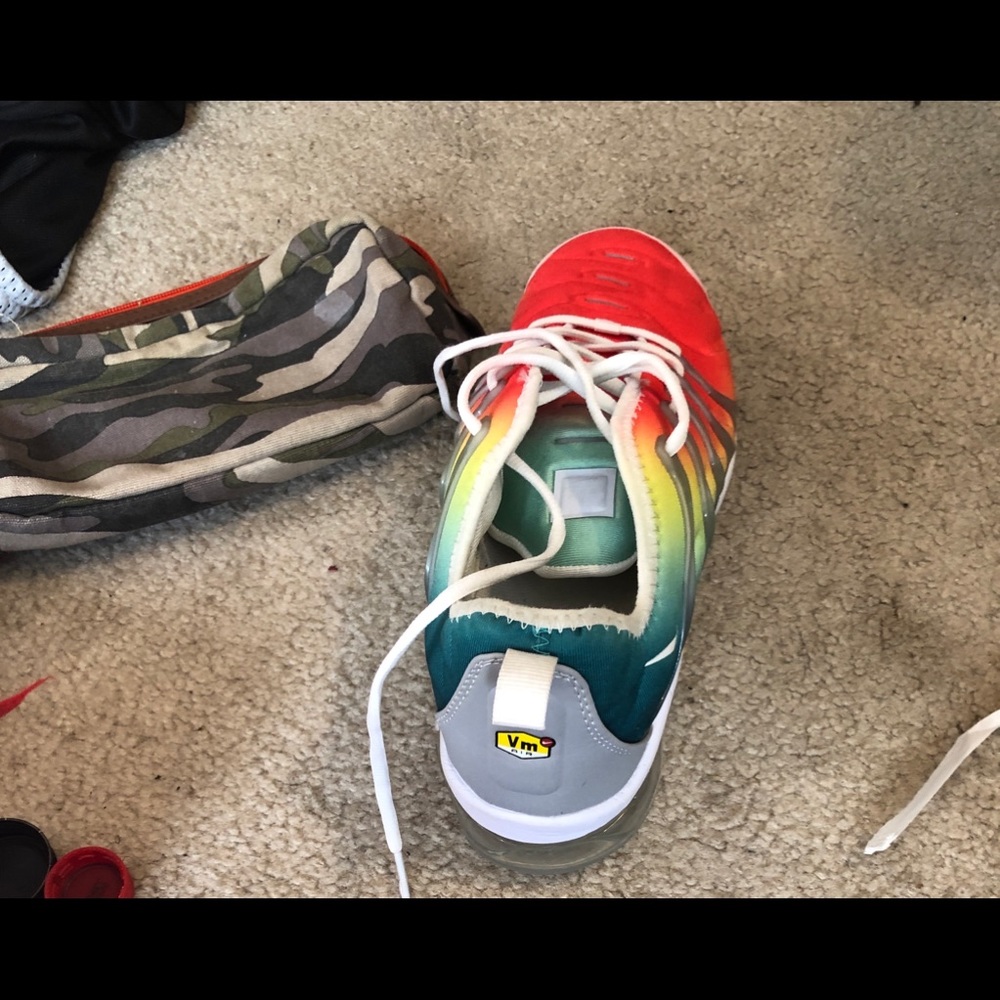 Nike vapor max plus. The colors are orange yellow green and red.